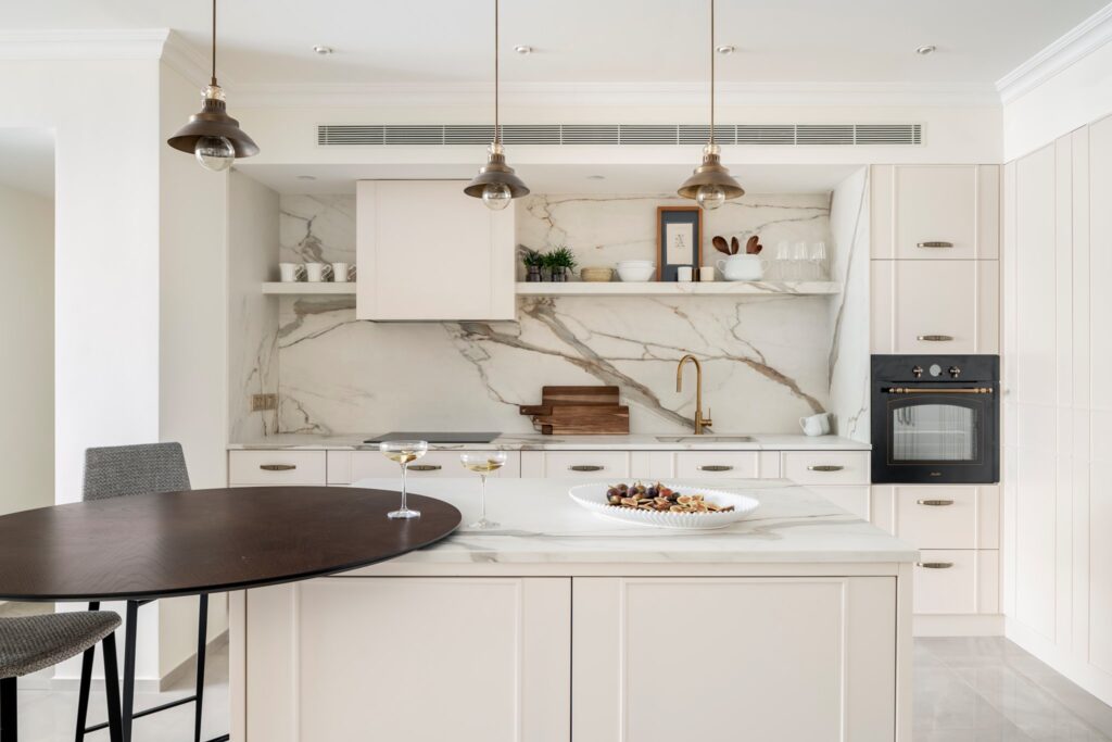 Modern Sarasota kitchen with a Calacatta marble-look porcelain countertop and backsplash, designed with elegant gold veining.