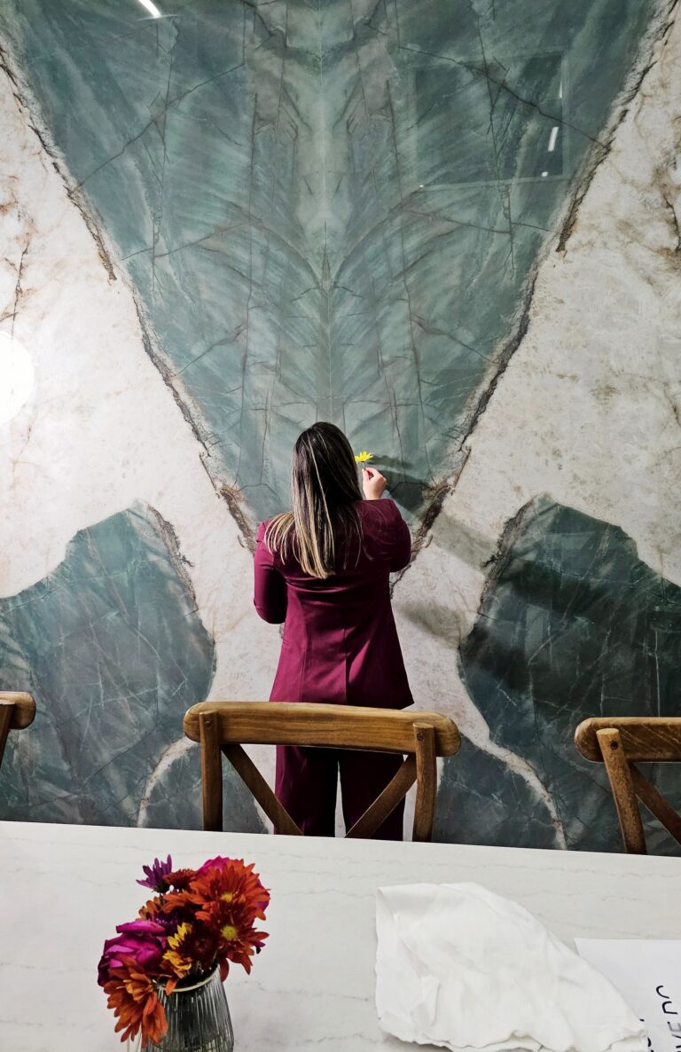 Person standing in front of a large-format porcelain slab showcasing its scale and seamless design.