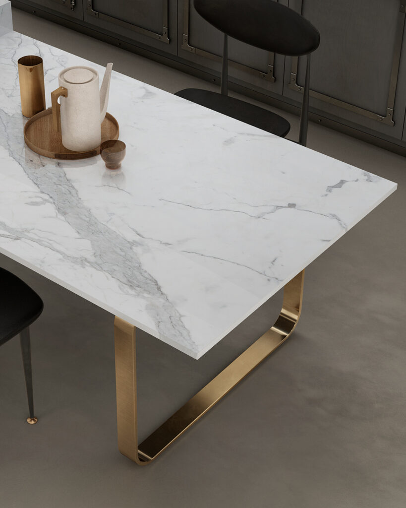 Elegant white dining table featuring the intricate veined pattern of Calacatta marble effect from Infinity Surfaces. This lifelike marble look is achieved with their innovative Vein Tech technology, where the veins extend through the entire slab.