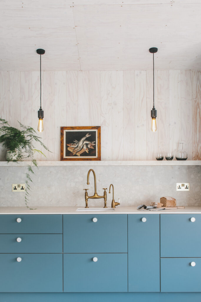 Modern kitchen featuring a Neolith Retrostone terrazzo look countertop and wall.