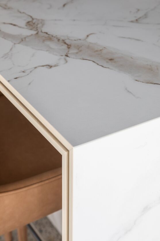 Close-up of a Dekton Entzo countertop, showcasing its elegant marble-look veining and a thin, double-edge profile with precise fabrication.
