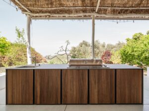 Premium Dekton outdoor kitchen countertops seamlessly installed over modern marine-grade aluminum cabinets on a luxury Longboat Key estate patio.