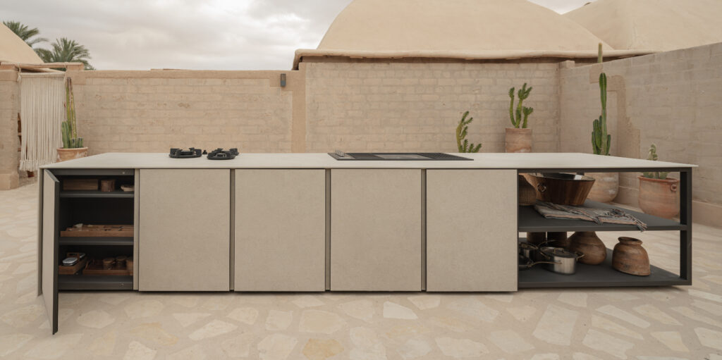 Close-up view of a high-heat resistant Dekton outdoor kitchen countertop featuring a precise cutout for a professional built-in gas grill on a luxury pool deck.