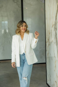 Lais Luz inspecting Infinity Surfaces porcelain slabs at UMI Stone Sarasota for countertop and architectural applications.