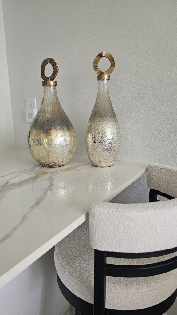 Complete Sarasota kitchen makeover featuring bookmatched Infinity Calacatta Oro polished porcelain slabs for a seamless, modern luxury aesthetic.