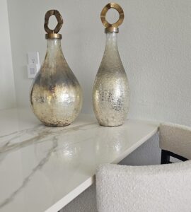 Complete Sarasota kitchen makeover featuring bookmatched Infinity Calacatta Oro polished porcelain slabs for a seamless, modern luxury aesthetic.